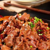 Mongolian Beef 蒙古牛肉 · Sliced tender beef seared with onions and scallions in brown sweet hoisin sauce