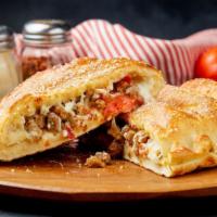 6 Meat Calzone · Italian Sausage, Beef, Bacon, Pepperoni, Canadian Bacon, and Sausage.