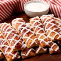 Cinnamon Breadsticks · Bread sticks sprinkled with cinnamon and sugar and drizzled with sweet icing.