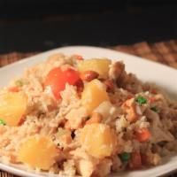 Pineapple Fried Rice · Thai style pineapple fried rice with onions, carrots, cucumbers, tomatoes, cashew nut, and g...