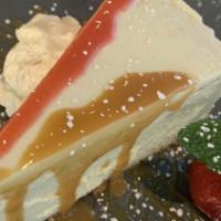 Cheesecake · Cheesecake, whipped cream, strawberry, fresh mint, sugar powder.