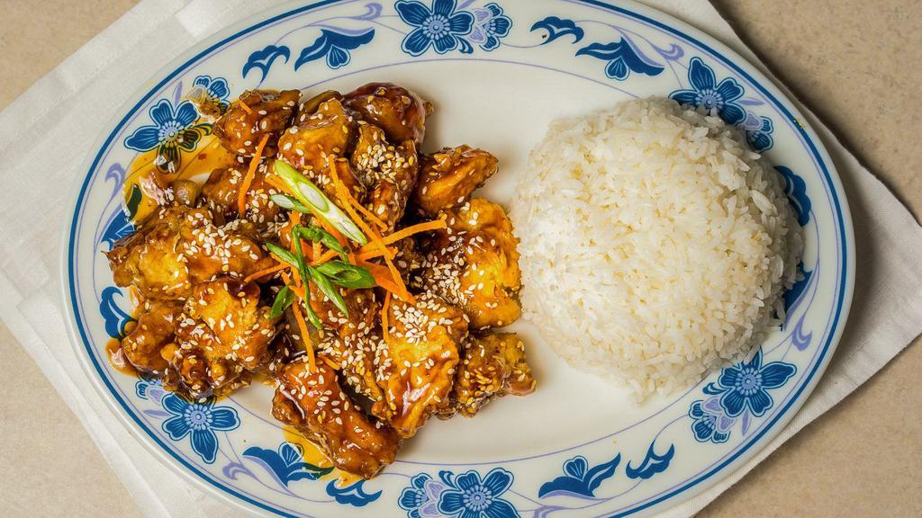 Sesame Chicken · Breaded white meat chicken, stir fried in a spicy sweet tangy sauce with sauteed onions, topped with sesame seed and green onions.