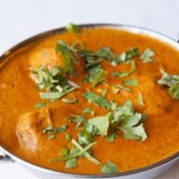 Malai Kofta · Minced vegetable dumplings cooked in a cream sauce and garnished with cashews and raisins.