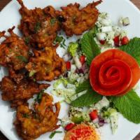 Onion Pakora · A tea-time favorite, sliced onions with diced potatoes and spinach complimented with spices ...