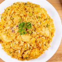 Chicken Biryani · A Mughlai dish prepared with chicken and green peas with saffron flavorful rice, garnished w...