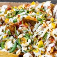 Michos Nacho Box · Served over white corn tortilla chips, with choice of toppings and sauce.