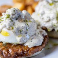 Biscuit & Gravy Benedict · Poached eggs, sausage patties, sausage gravy, buttermilk biscuit, chive oil, chives