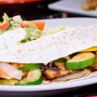 Vegetarian Quesadilla · A flour tortilla stuffed with grilled tomatoes, onions, green peppers, mushrooms, and shredd...