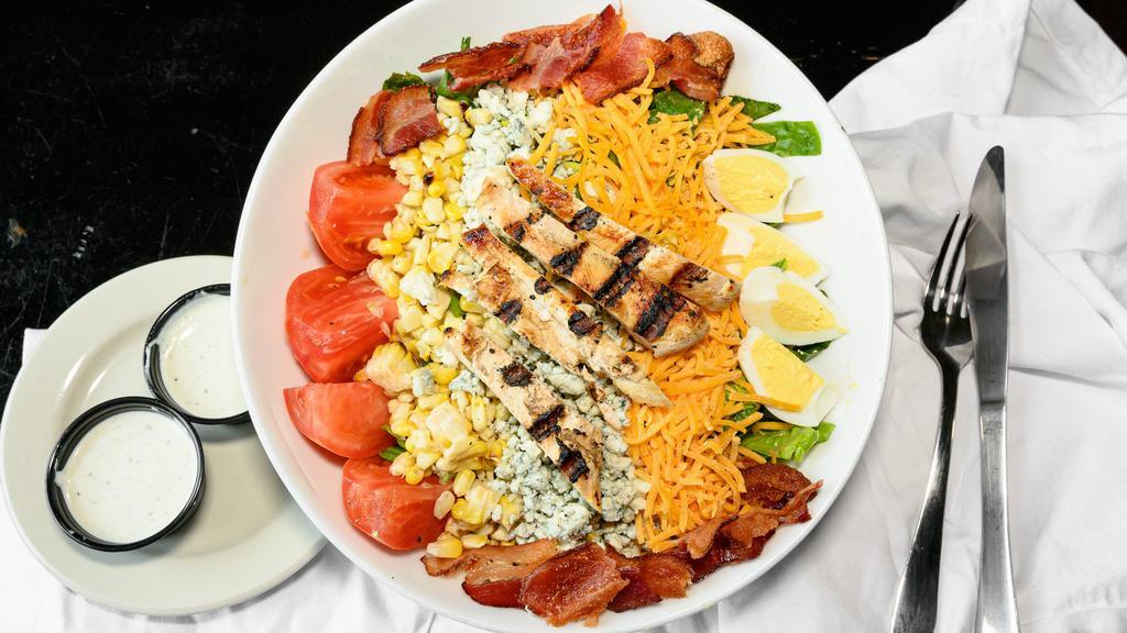 Basil Cobb Salad · Grilled chicken, cheddar cheese, bleu cheese crumbles, bacon, egg, tomatoes, roasted corn over a romaine/basil blend with a side of ranch dressing
