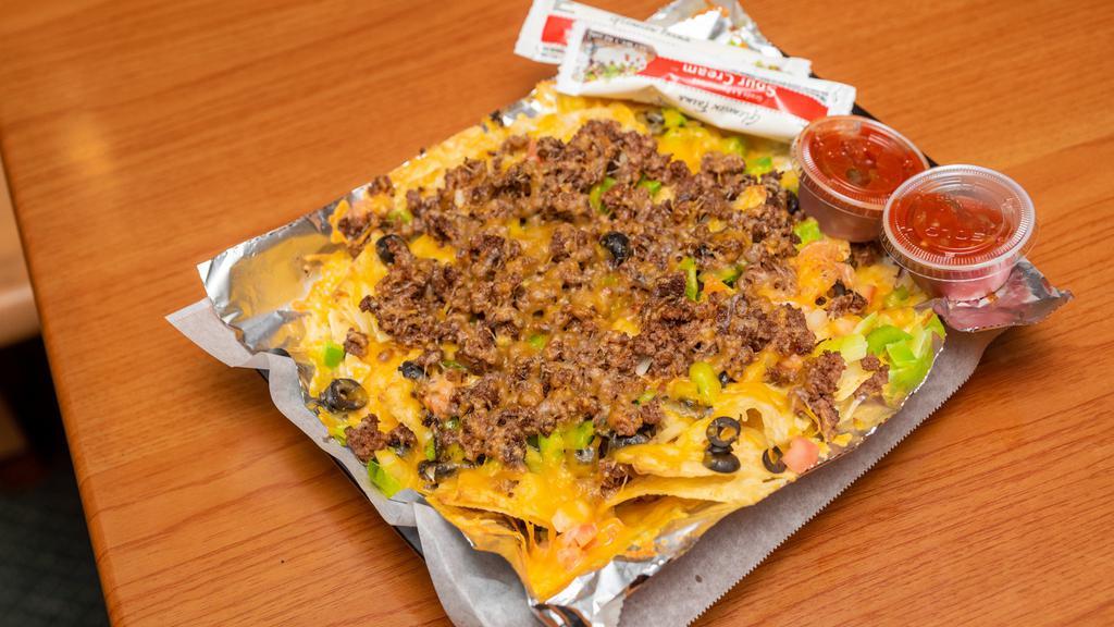 Nacho Supreme · Chicken or beef, green peppers, onions, tomatoes, black olives and cheddar.