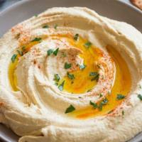 Hummus · Homemade and served with pita, carrots, celery and cucumbers.