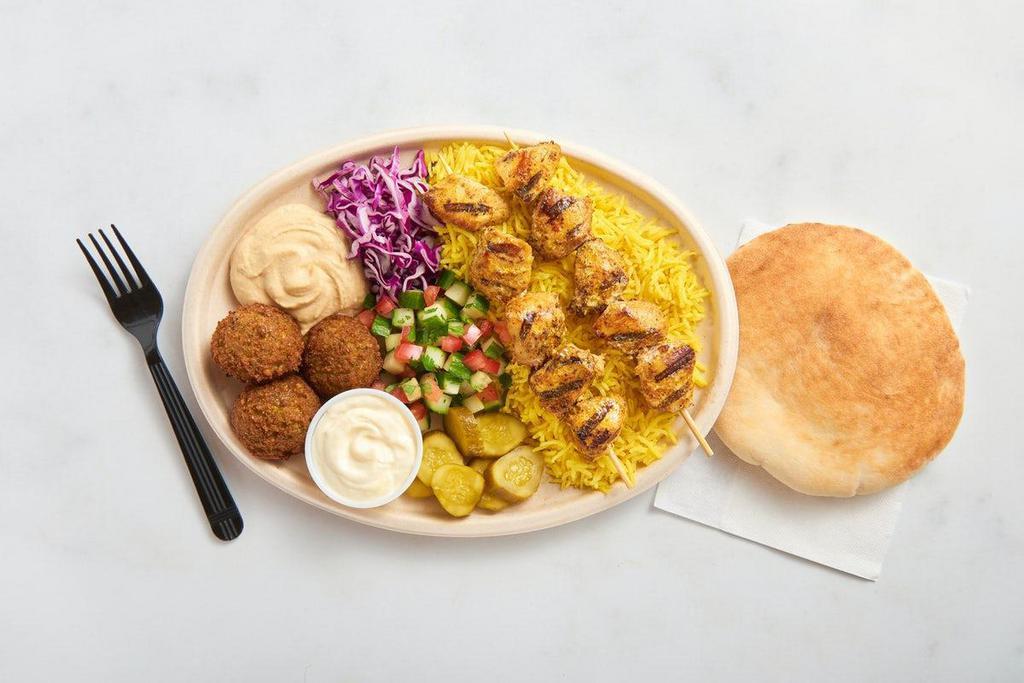 Chicken Breast Kebab Plate · 2 chicken breast kebabs, basmati rice, 3 falafel, hummus, garlic sauce, chopped salad, purple cabbage, Middle Eastern pickles, and a fresh-baked pita. No substitutions.