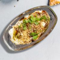 Miss Samosa Chaat · Two vegetable samosas topped with cucumbers, onions, yogurt, cilantro and a chaat masala.