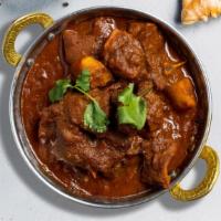 Goat Vindaloo · Bone-in goat meat cooked in our special housemade curry masala, dry chili, red and yellow di...