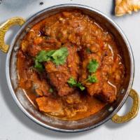 Fish Vindaloo · Boneless tilapia fish cooked our special housemade curry masala with potatoes, garlic, vineg...