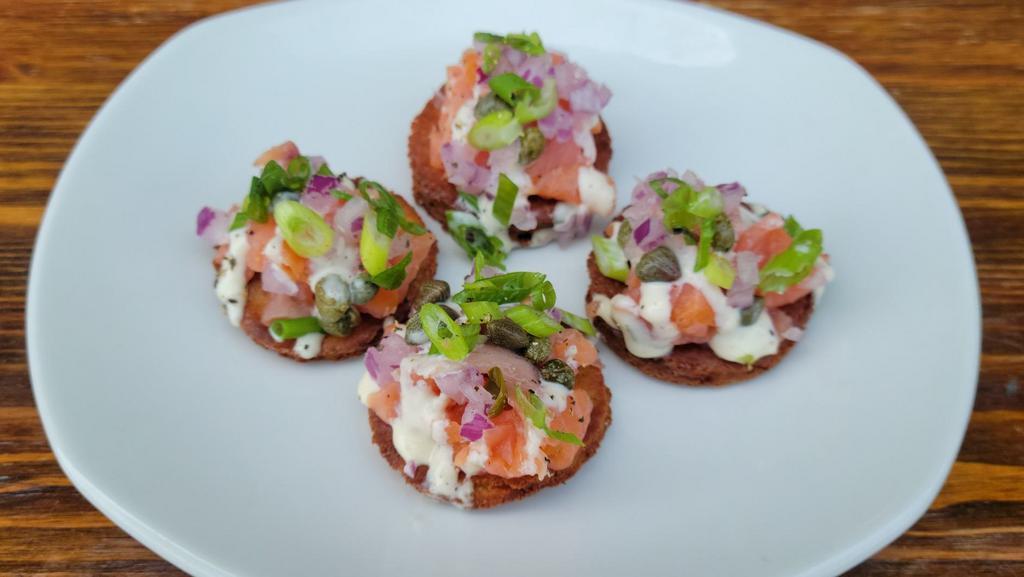 Smoked Salmon Bites · Cold oak-smoked salmon with capers onions, light horseradish sauce, lemon, on cucumber slices.