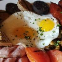 Irish Breakfast · Two eggs, Irish sausages, rashers, black, and white pudding, mushrooms, tomatoes, sourdough ...