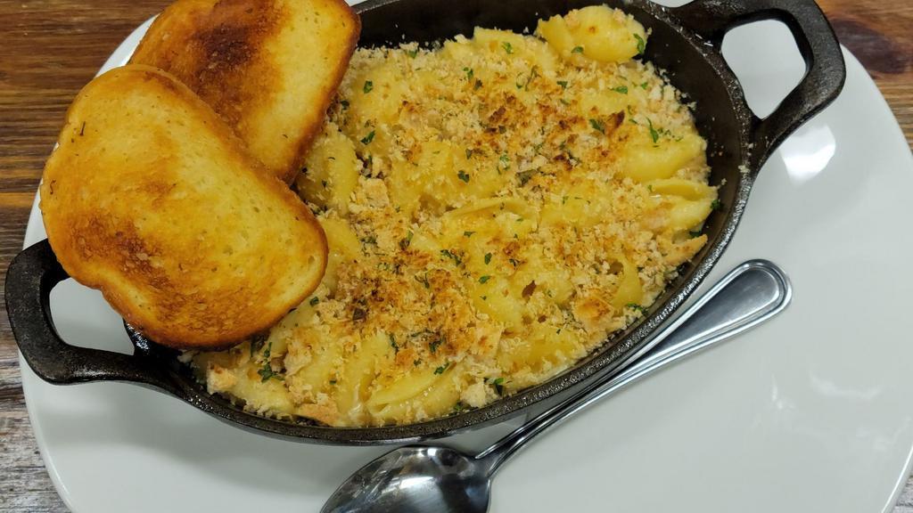 Guinness Mac And Cheese · Medium shells tossed in our Guinness cheddar mac sauce. Topped with breadcrumbs and baked golden brown