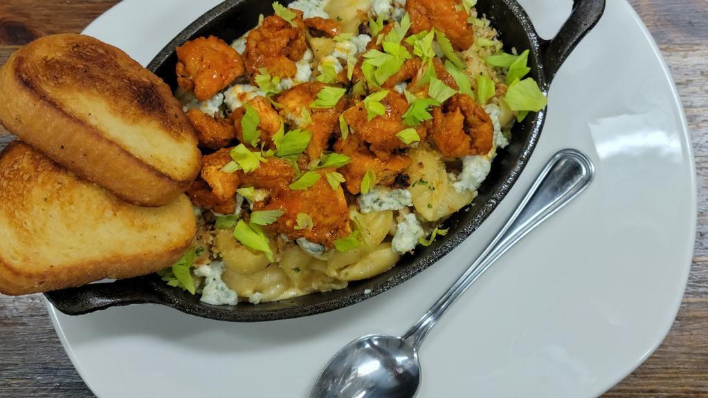 Buffalo Mac And Cheese · Our signature Guinness Mac and Cheese topped with crispy fried chicken tossed in buffalo, celery leaves and blue cheese crumbles.