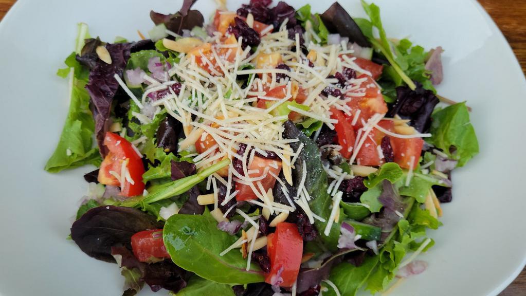 Farmhouse Salad · Mixed greens, cucumber, red onion, marinated tomatoes, dried cranberries, toasted almonds, Asiago cheese with red wine vinaigrette.