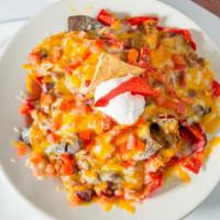 Ultimate Nachos · Tri-colored corn tortilla chips smothered with cheese, chili, tomato, green onion, and sour ...