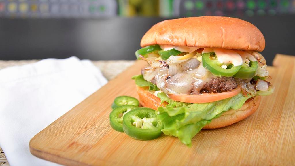 Fireball Burger · Pepper jack cheese, fresh green jalapenos, crushed red pepper, a mix of sriracha, and mayo, creamy nacho cheese, lettuce, tomatoes, and grilled onions. All between soft brioche bun.