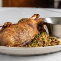 Half Roasted Duckling · Crisp duckling served on a bed of wild rice and grand marnier orange sauce.