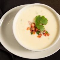 Queso Blanco (Cup) · Rich and Spicy Blend of Melted White Cheeses,
Fresh Tomatoes and Poblano Peppers.