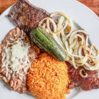 Carne Asada Dinner · Grilled steak served with Mexican rice, refried beans, grilled jalapeños and onions, lettuce...