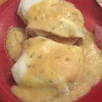 Eggs Benedict · English muffin topped with ham and 2 basted eggs with hollandaise, served with fruit or potato