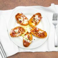 Loaded Potato Skins · Five potato skins stuffed with cheddar cheese, smoked bacon, and chives, served with sour cr...