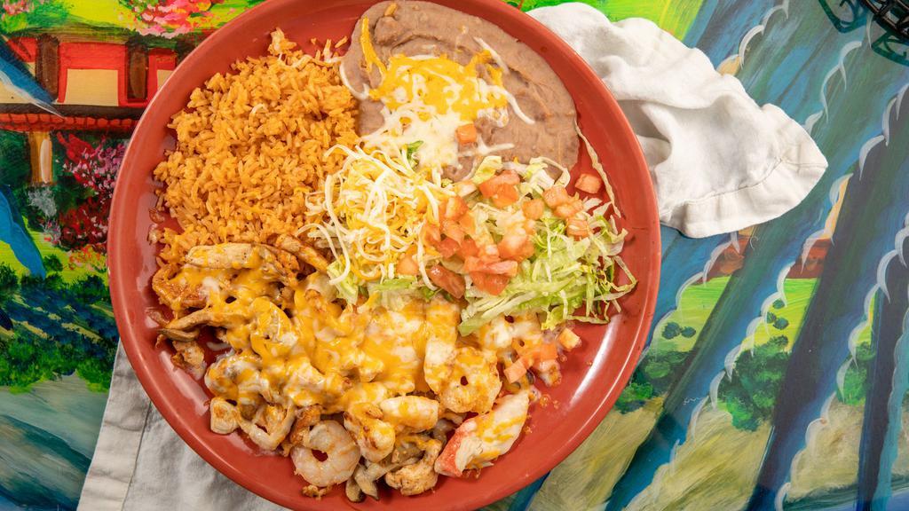 Puerta Vallarta Platter · Crab meat, shrimp, strips of chicken breast, and mushrooms sautéed in wine, topped with cheese. served with rice and beans, tortillas, and garnished with lettuce and tomatoes.