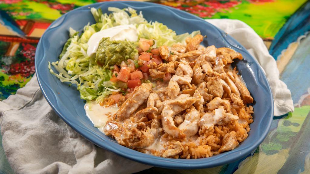 Arroz Con Pollo Gf · Grilled chicken over a bed of rice covered in cheese sauce served with guacamole salad, sour cream, and tortillas.