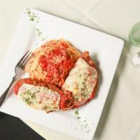 Parmesan · Breaded chicken breast with tomato sauce and Mozzarella, bed of angel hair.