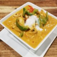33 Panang Curry · Sliced meat in panang curry with bell pepper topped with coconut milk.