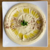 Hummus · Chickpeas pureed with tahini and lemon juice and topped with a drizzle of olive oil.