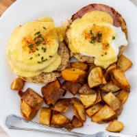Classic Eggs Benedict · Toasted English muffin topped with Canadian bacon, poached eggs, and hollandaise sauce. Serv...