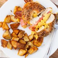 Everything Bagelwich · Grilled everything bagel, bacon, scrambled eggs, tomato, chive cream cheese. Served with hom...