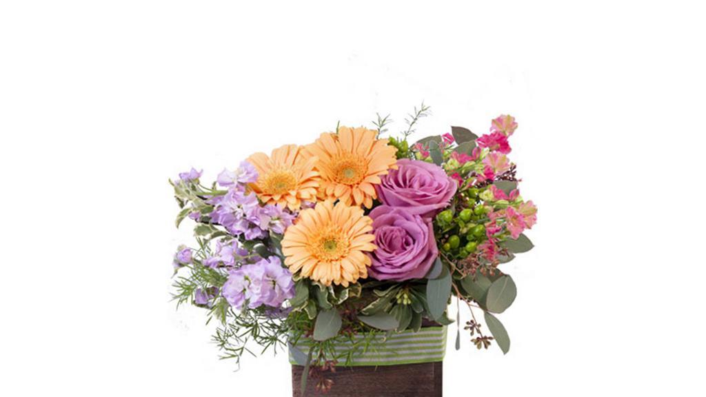 Blooming Wild (Shown As Deluxe)) · This delightful bouquet is sure to captivate! Filled with gorgeous peach gerberas, lavender roses, pink larkspur, lavender stock, and more, Blooming Wild is a delicate and elegant mix. Send this stunning pastel arrangement to someone you love today!

Some flowers and containers may have to be substituted depending on seasonal demand and availability.  We will do our best to insure you love the final product.