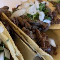 Street Tacos · Three soft corn tortillas stuffed with your choice of meat, topped with fresh cilantro and o...