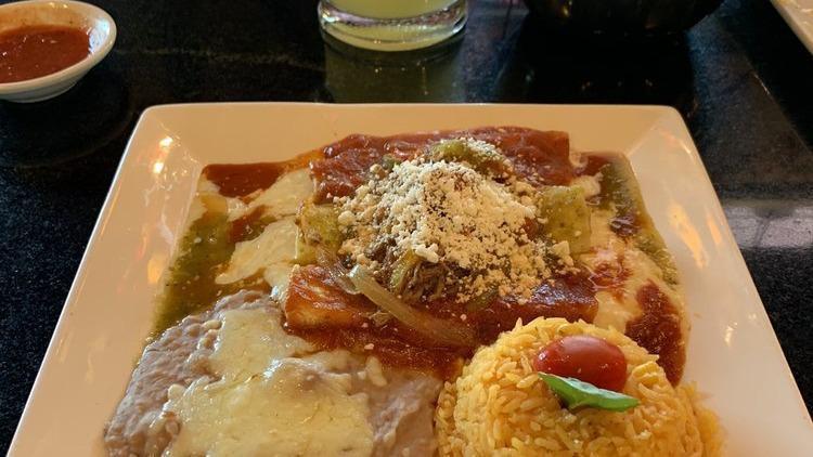 Enchiladas Rancheras · Three cheese enchiladas topped with red sauce and shredded beef. Served with rice and beans.