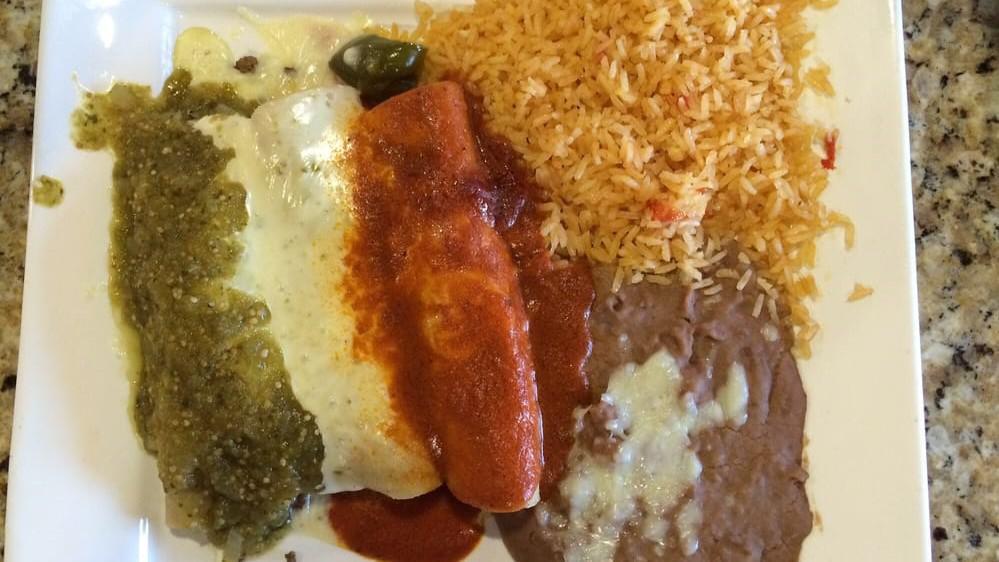 Enchiladas Tres Marias · Three enchiladas stuffed with steak or grilled chicken, one topped with green sauce, one with cheese sauce and one with red sauce, served with rice, lettuce, tomatoes, shredded cheese and sour cream.