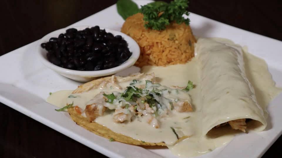 Loco Pepe'S · One burrito filled with your choice of meat: grilled chicken, steak or pork, cilantro, chopped onions and shredded cheese, topped with cheese sauce, and one chile conqueso, all served with rice and black beans.