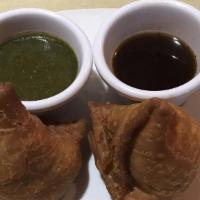Samosa (2 Pieces) · Triangular pastry stuffed with spiced potatoes and green peas.