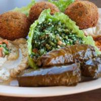 Appetizers Combo · Vegan. Three falafel, three stuffed grape leaves, hummus, Baba ghanouj, tabbouleh, served wi...