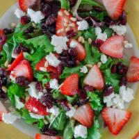 Ensalada De Fresa · Mixed greens and goat cheese salad with strawberries, dried cranberries and pine nuts with b...