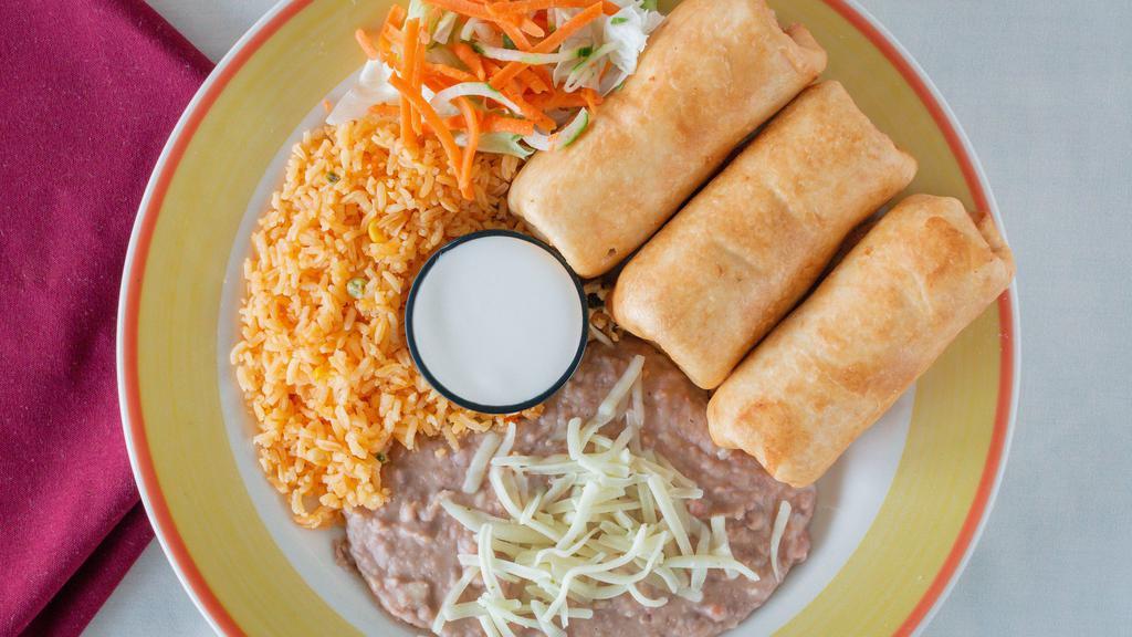 Chimichangas · Your choice of chicken or ground beef and cheese inside. Served with sour cream and garnish salad on the side. With steak for an additional cost. Served with rice and beans.