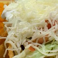 Taco Salad · Edible flour tortilla bowl with your choice of chicken or ground beef and topped with avocad...