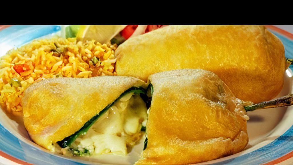 Chiles Rellenos De Queso · Vegetarian Favorite. Two green Poblano peppers stuffed with cheese, coated with egg batter and pan-fried.