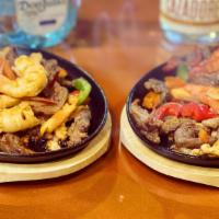 Fajitas · Choice of protein. Salted with mixed vegetables. Served with rice, beans, deluxe, and tortil...